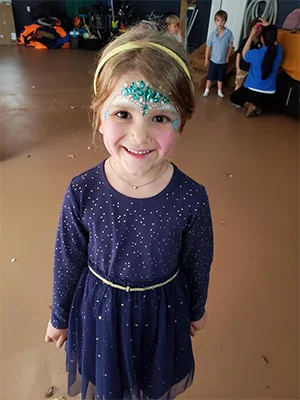 girl with glitter and gems face painting