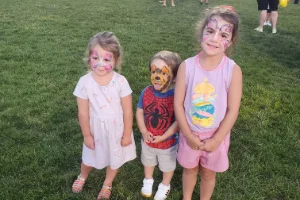 Image of three kids with their faces painted