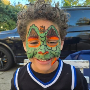 A boy with a reptile facepainting