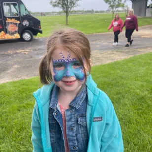 A little girl with a butterfly facepainting