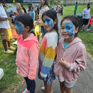 Three girls with matching blue fish facepaintings