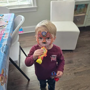 A young boy with a paw patrol facepainting