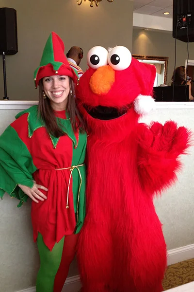 Elf and Elmo costume characters at party
