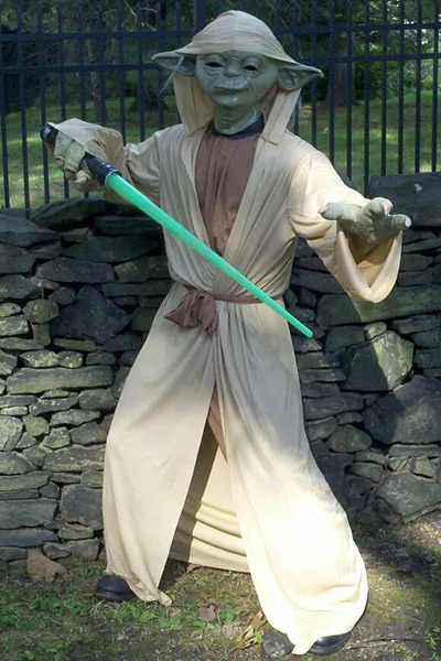Yoda hero costume with light saber at kid's birthday party