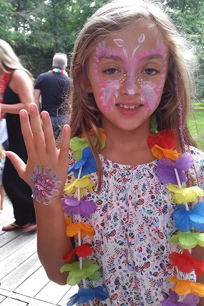 child's face painting of a butterfly and flower